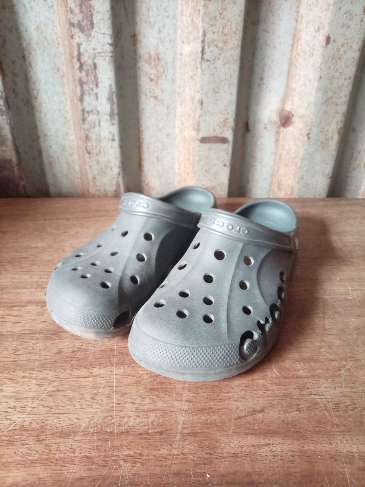Original Crocs UK10 — Grey Clog Pair, Branded Strap & Sole, Moderate Wear, Tear on Right Shoe