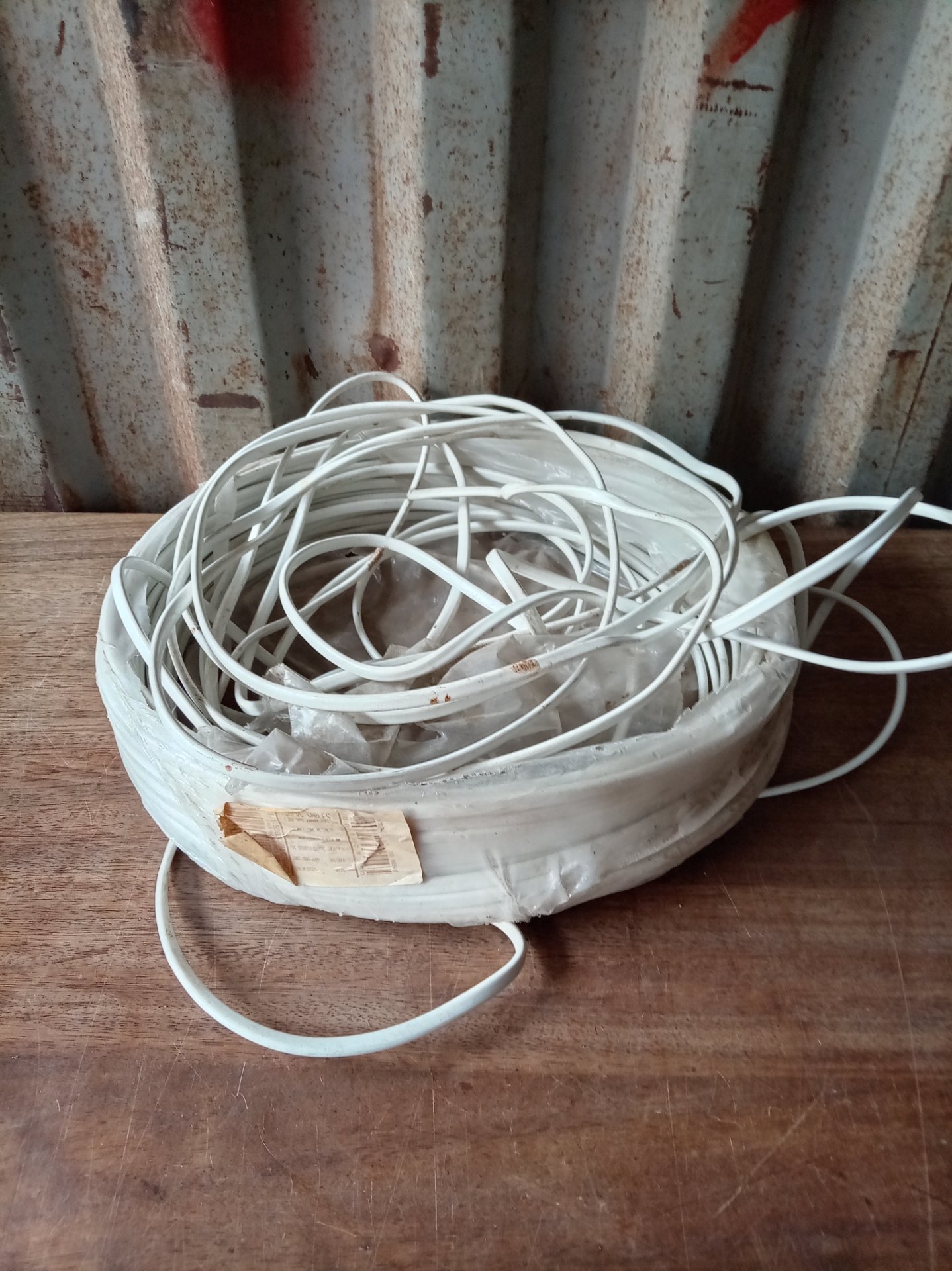 White PVC-insulated electrical cable coil — original label (appears 100 m) — used, untested