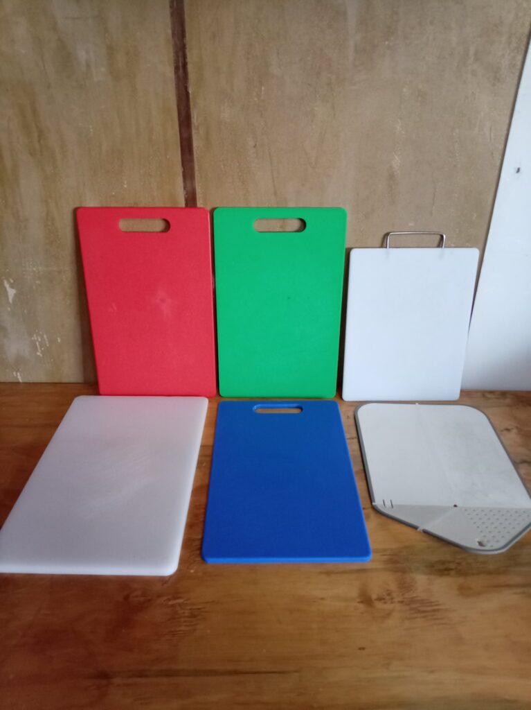 Lot of 6 assorted plastic cutting / chopping boards — mixed colours, good used condition