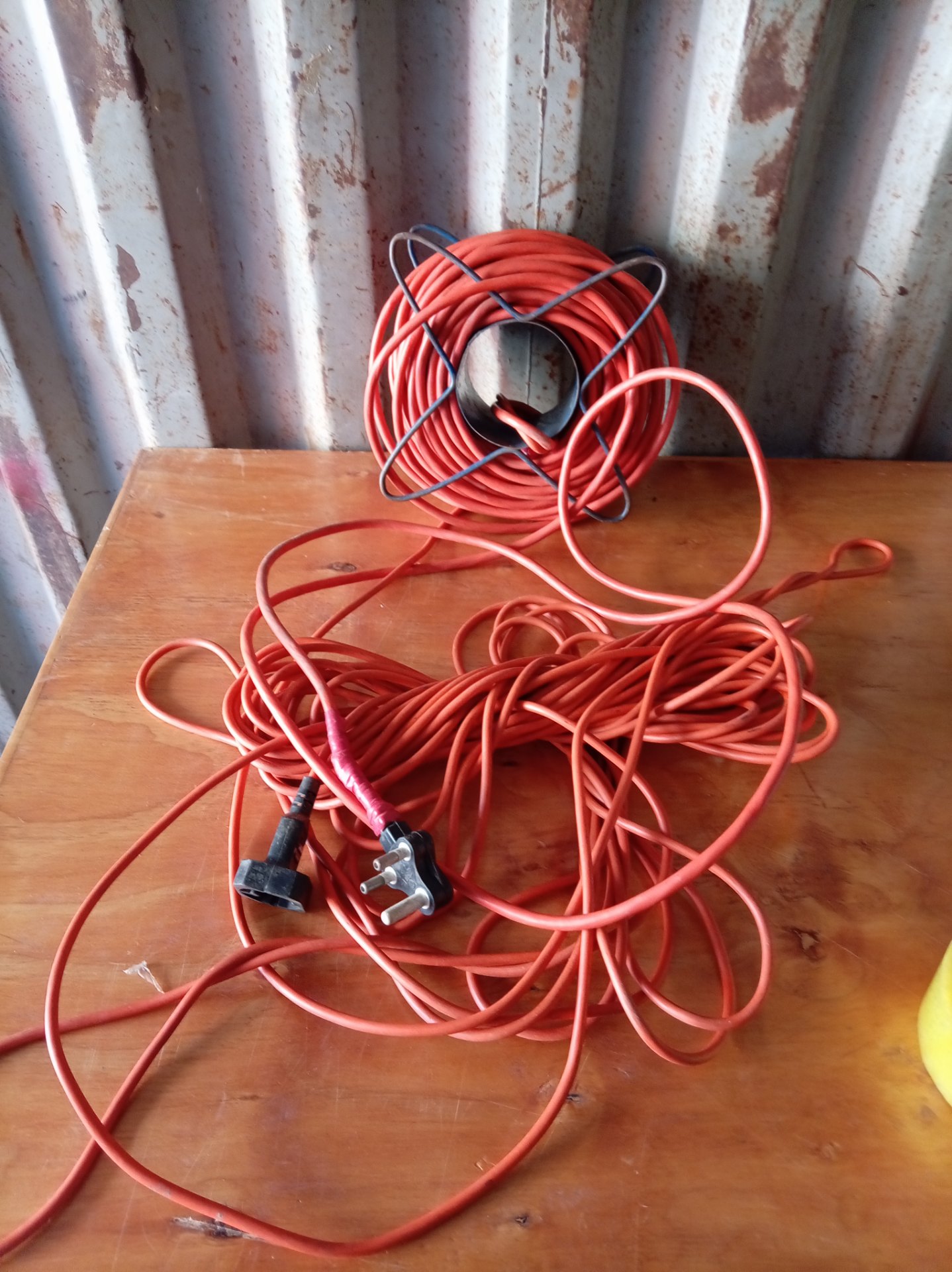 Orange extension cable on metal reel — long heavy-duty lead (UNTETSED, taped repair)