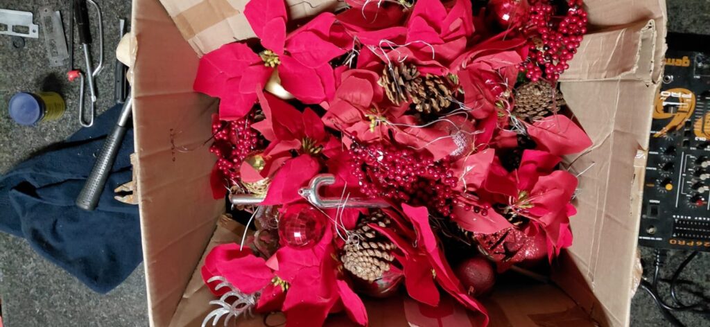Lot 09: Box of Mixed Red Christmas Decorations — Poinsettias, Baubles, Pinecones & Silver Toppers