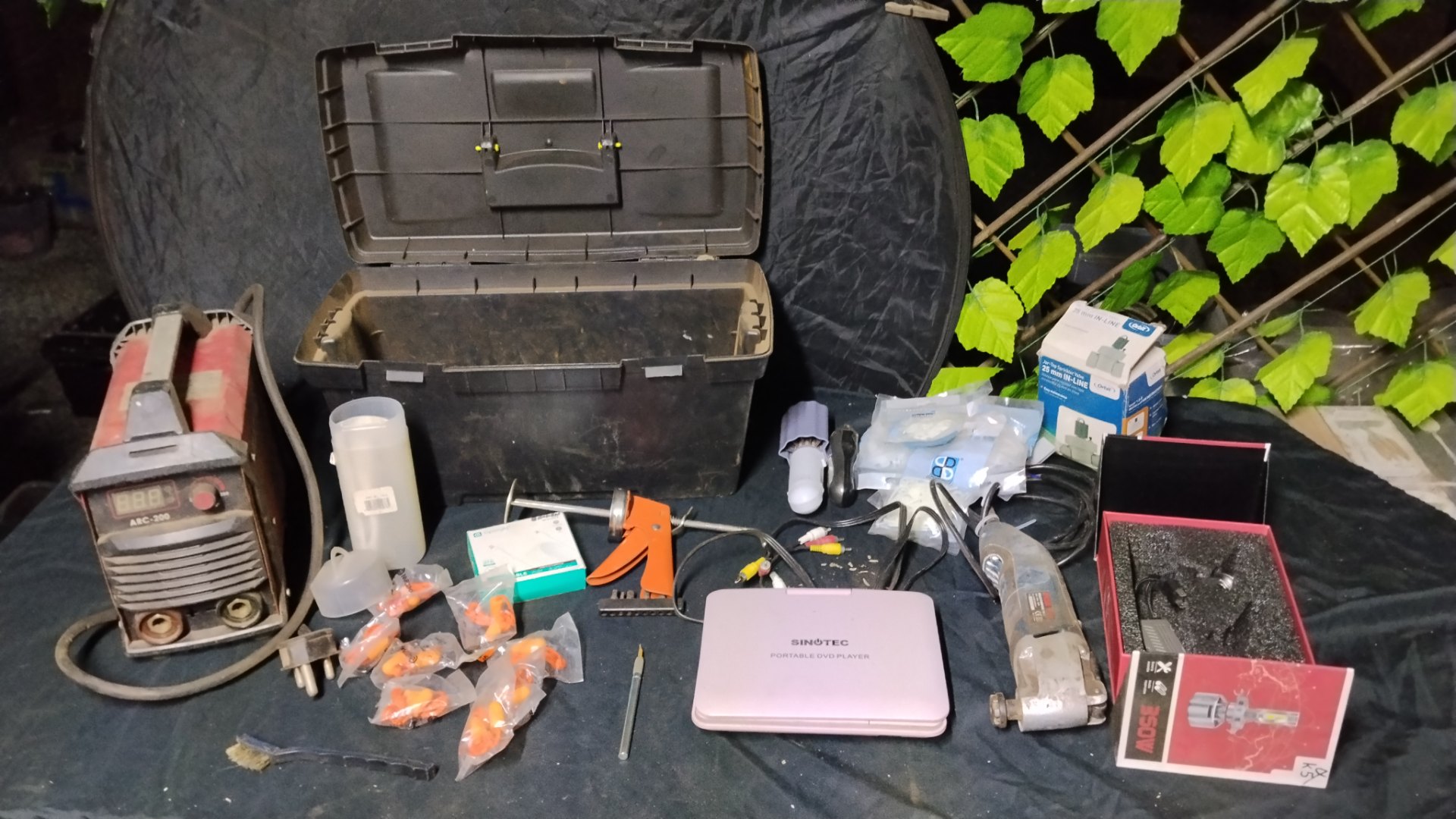 Mixed toolbox lot — taped plastic toolbox with assorted hand tools, ARC-200 welder, Ryobi multi-tool, Sinotec DVD, boxed LED bulbs & Orbit sprinkler valve (untested)