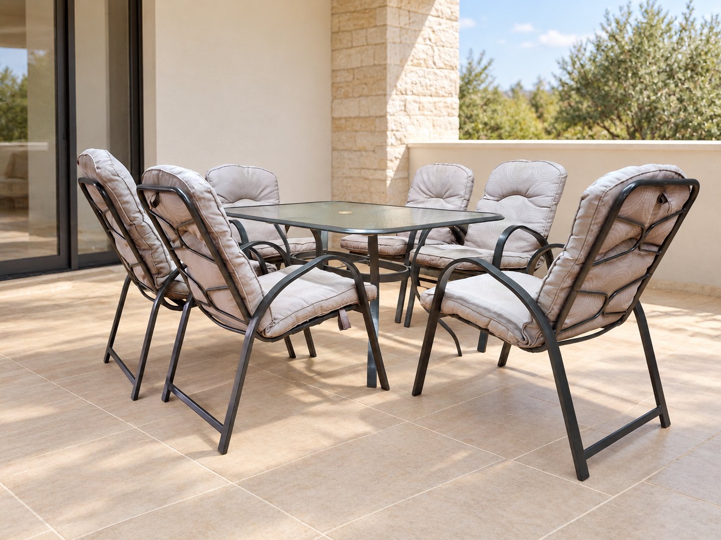 Outdoor 7-piece patio dining set – rectangular glass-top table + 6 cushioned metal chairs (used)