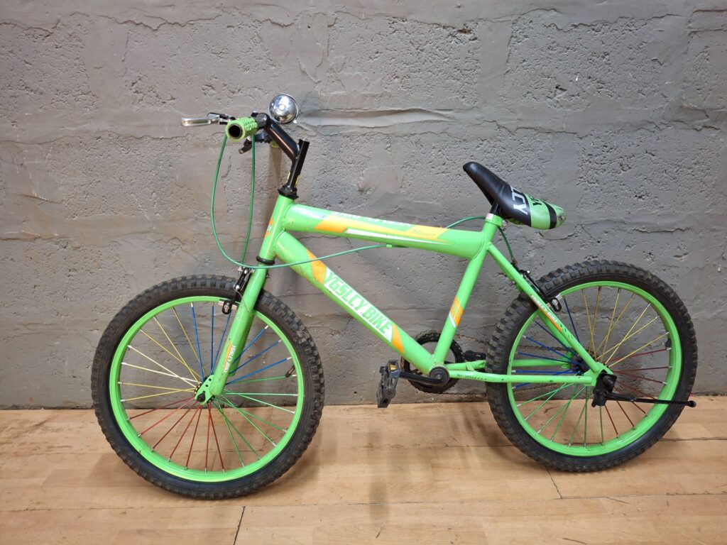 Green YGSLICY BIKE single-speed kids bicycle — tyres flat, brakes not working, torn saddle