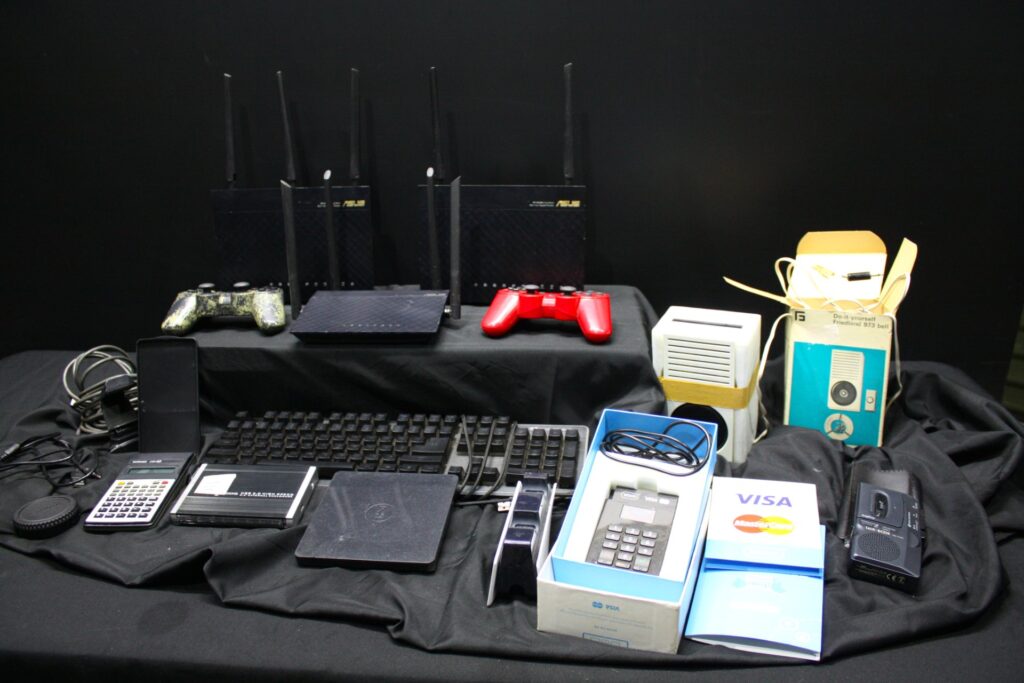 Mixed lot: ASUS routers (4), YOCO card terminal (boxed), controllers, keyboard, Sanyo Talk-Box & assorted accessories — Untested