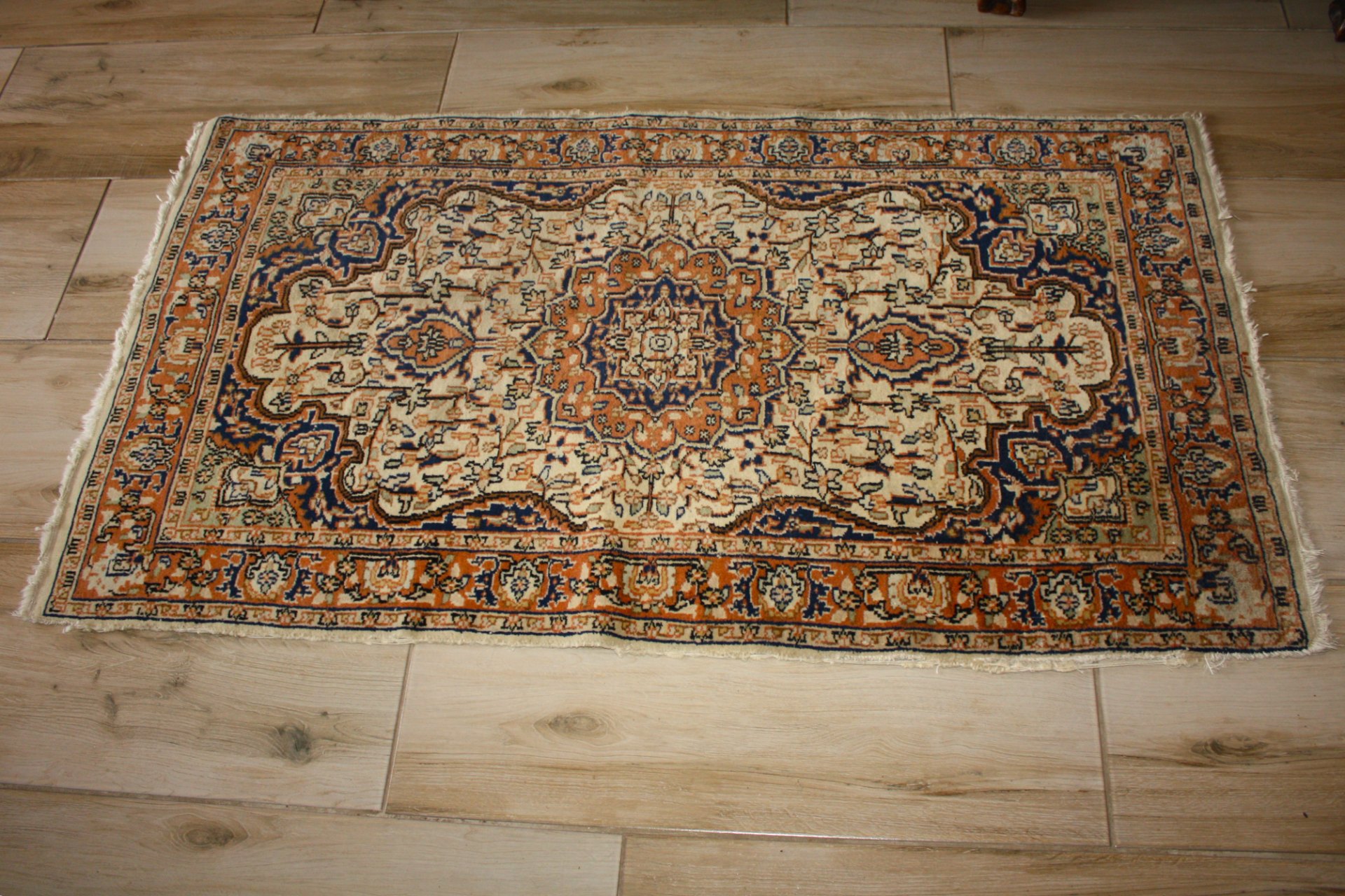 Oriental-style runner rug — cream, navy & terracotta medallion design (approx. 150 x 100 cm) — used, fringe wear