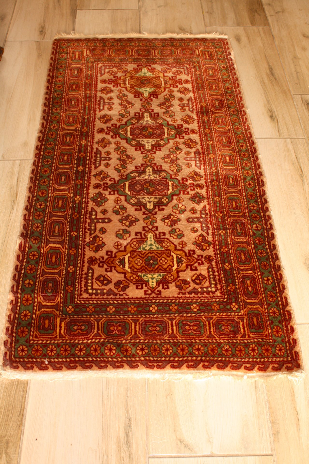 Oriental-style decorative runner — red/green/beige, labelled ‘AL 1130’ (approx. 125 × 200 cm)