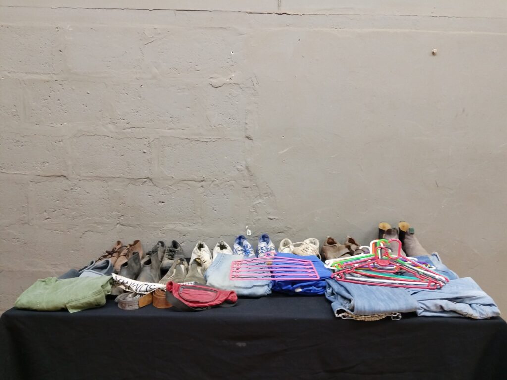 Mixed lot: Used shoes, jeans, tops, belts, hangers & accessories — 38 items (poor condition)