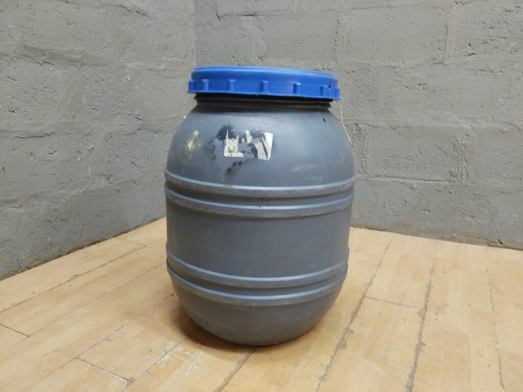 Used grey plastic screw-top storage drum with blue lid — 70cm H, 40cm Ø