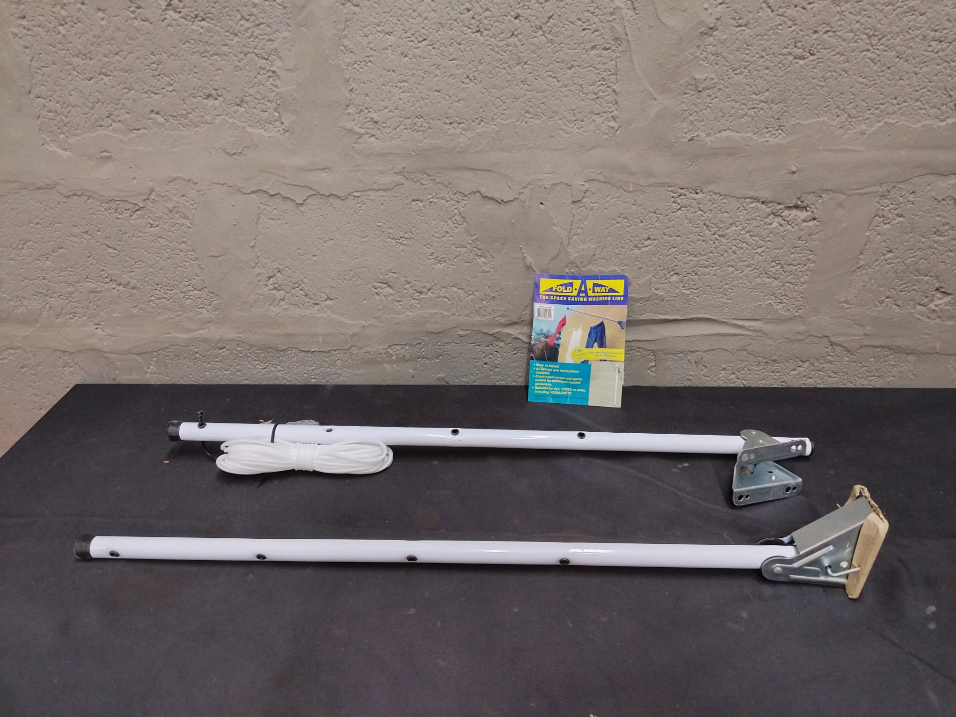 Fold-A-Way / Fold A Line wall-mounted folding clothesline arms with rope, brackets (used)