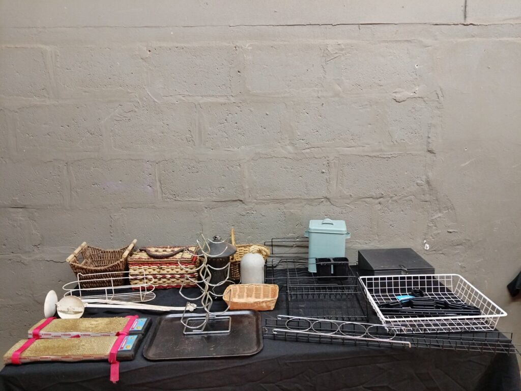 Mixed household lot — kitchen & storage racks, baskets, trays, hangers (approx. 19 items)