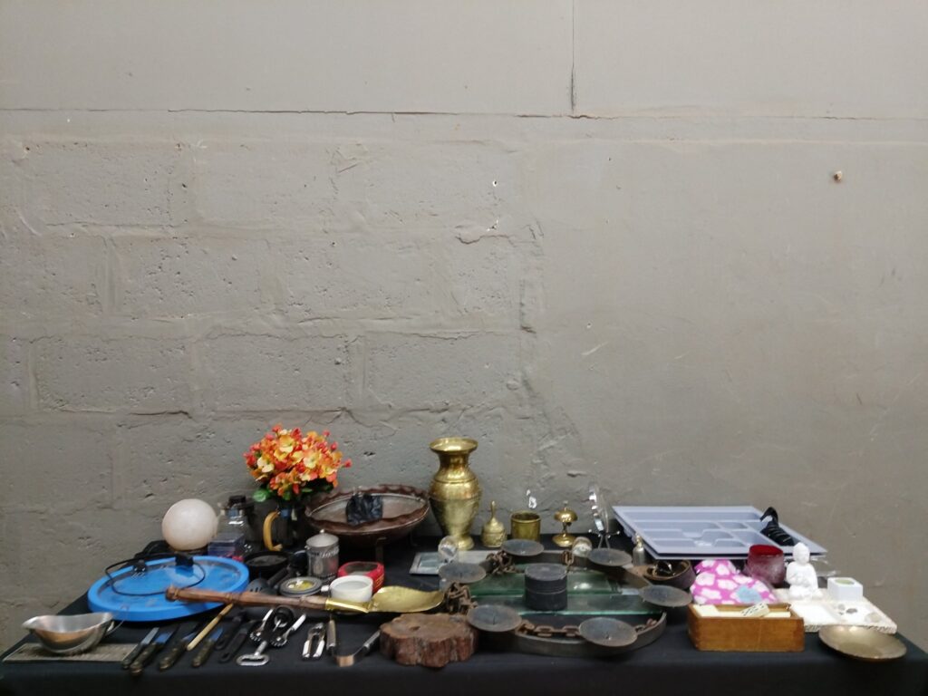 Mixed lot of 19 household & decorative smalls — brassware, old balance scales, kitchen tools, corded clock (not working)