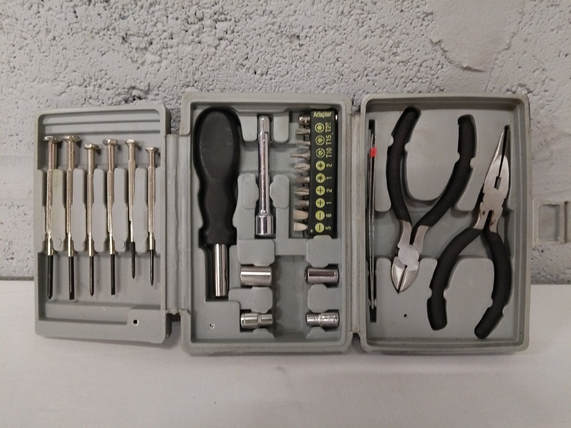 Compact Hand‑Tool Kit — precision screwdrivers, bits, sockets & 3 pliers in grey case (used)