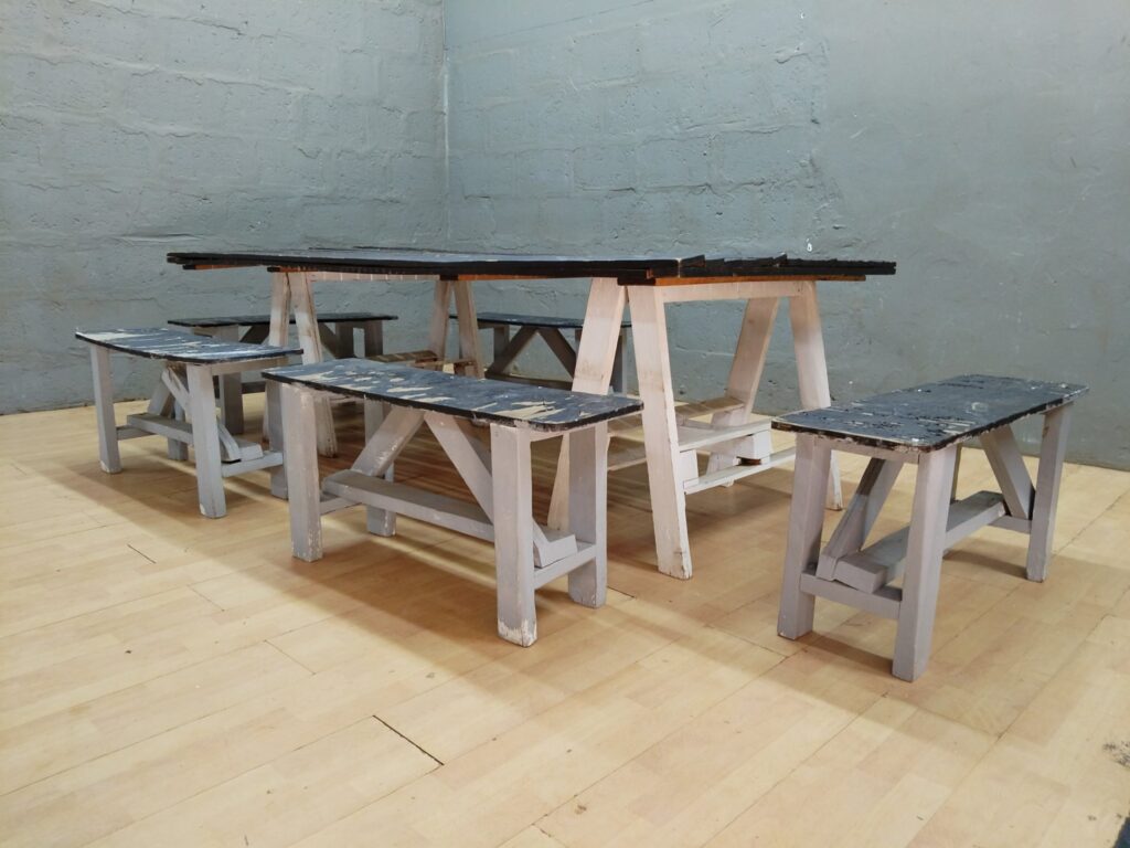 Long wooden picnic-style table + 5 benches — weathered, repair required