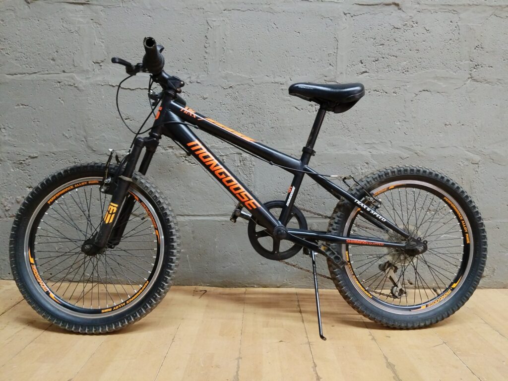 Mongoose TRAX 6 Speed mountain bike — black/orange, front suspension