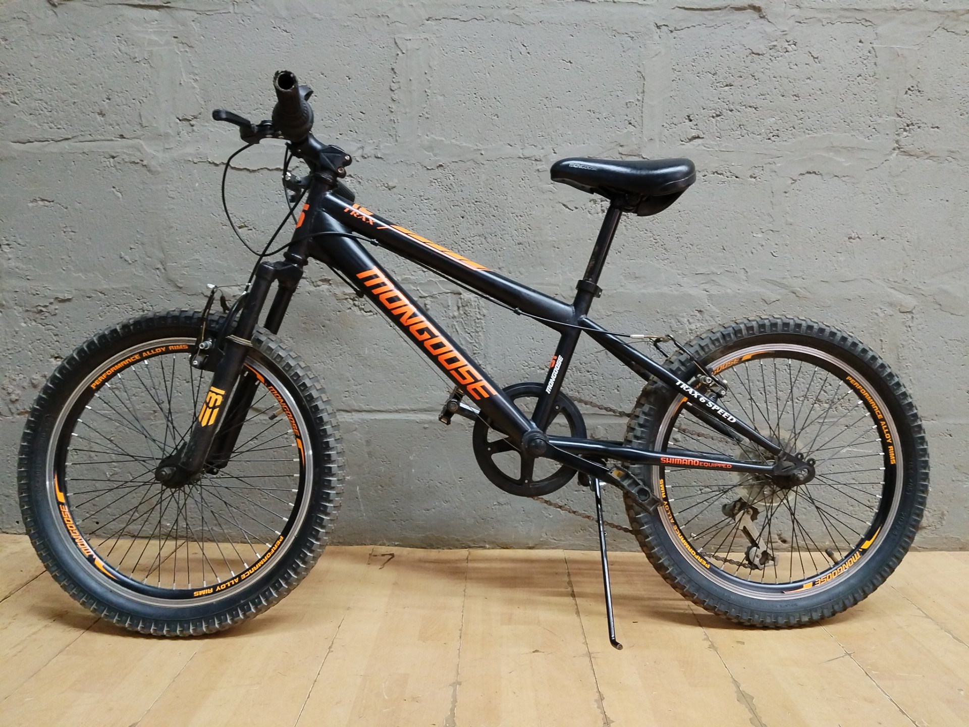 Mongoose TRAX 6 Speed mountain bike — black/orange, front suspension