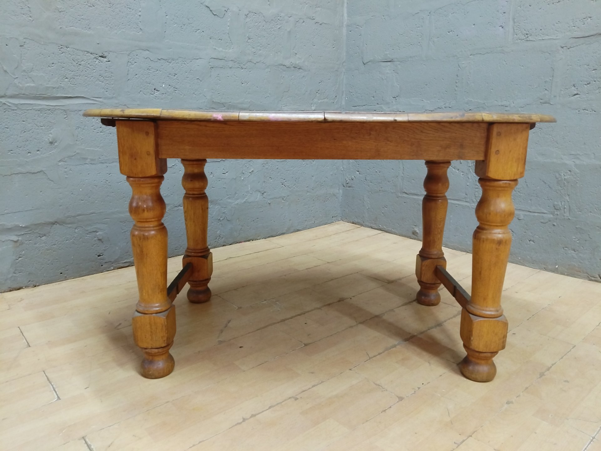 Solid-plank oval dining table with turned legs & stretchers — 140 x 105 x 75 cm (leaf missing)