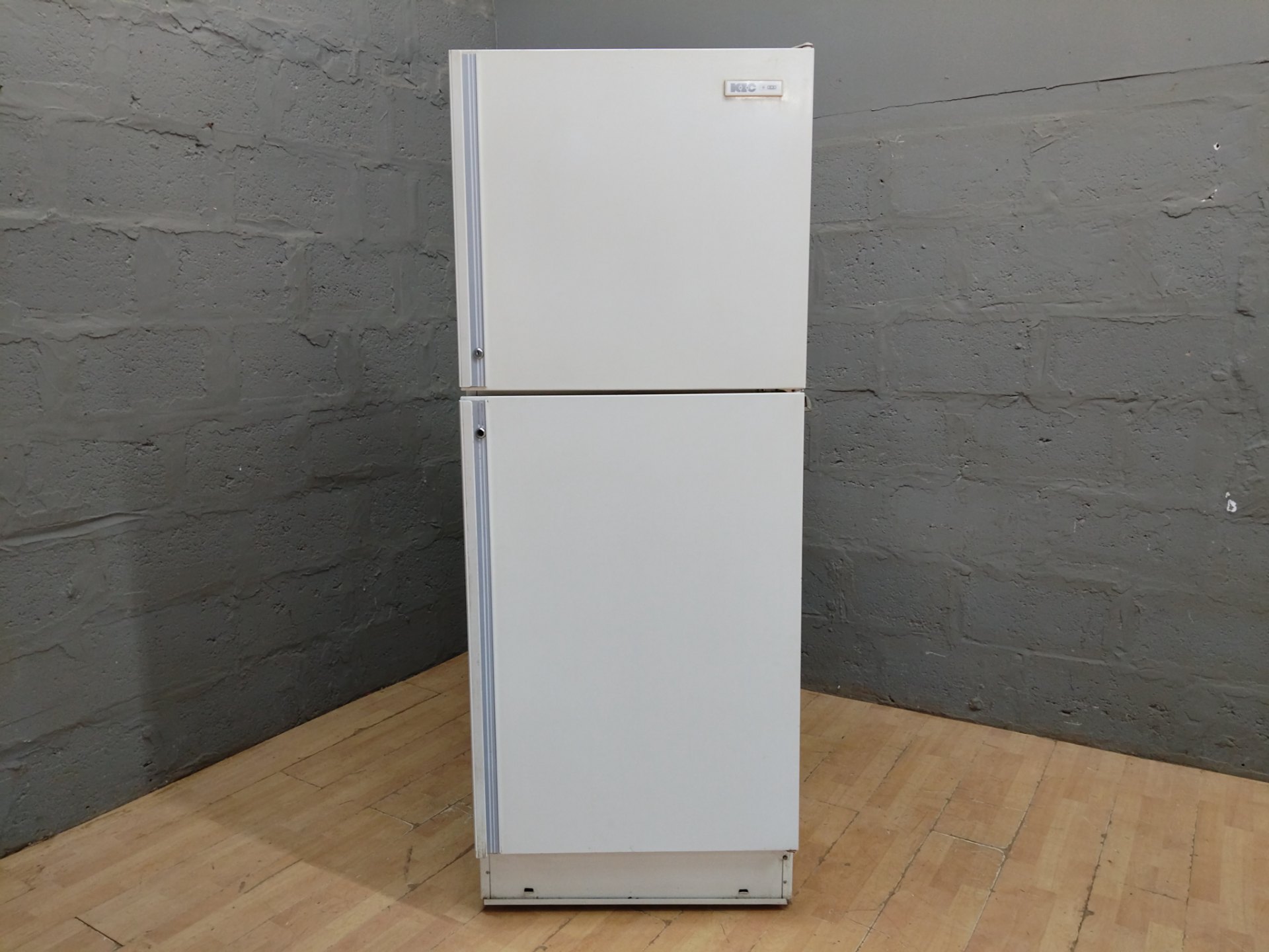 Top‑freezer refrigerator — warehouse-tested working; heavy cosmetic and interior damage, torn gaskets, exposed rear components