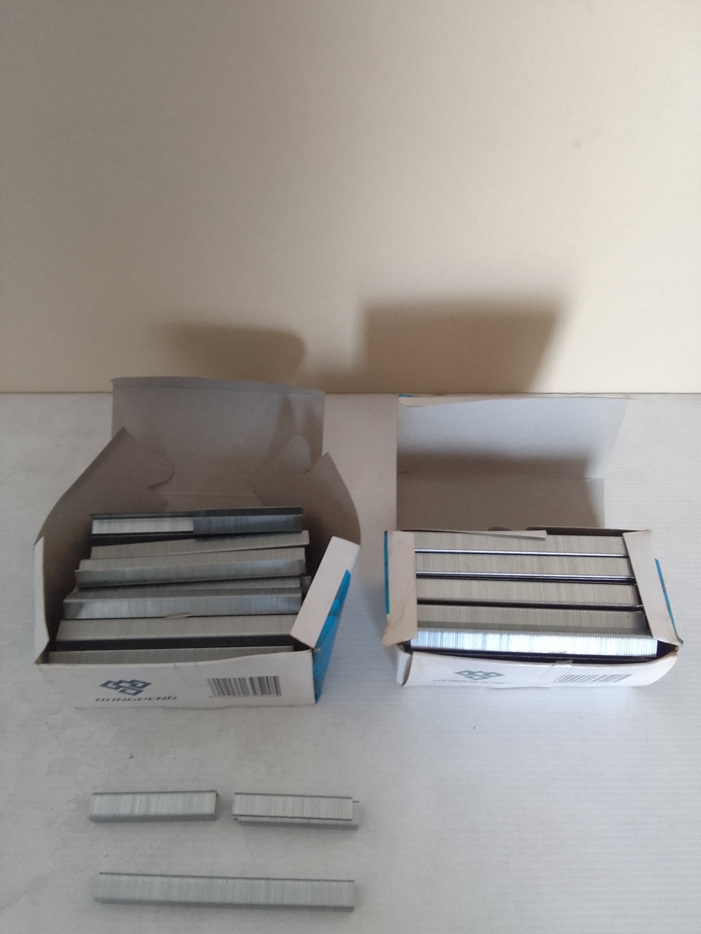Bulk lot of office staple strips — two opened boxes, mostly unused; some partial strips (stated size 1010mm)