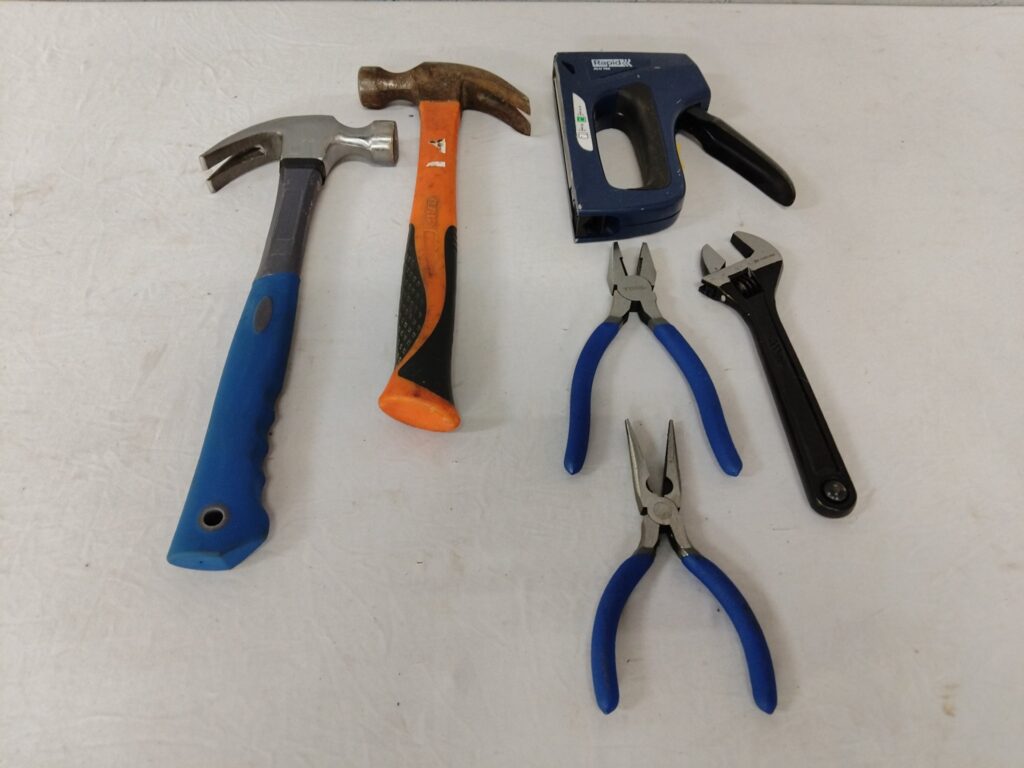 Mixed lot of 6 hand tools — 2 hammers, pliers, long-nose, adjustable spanner & Rapid staple gun (used)