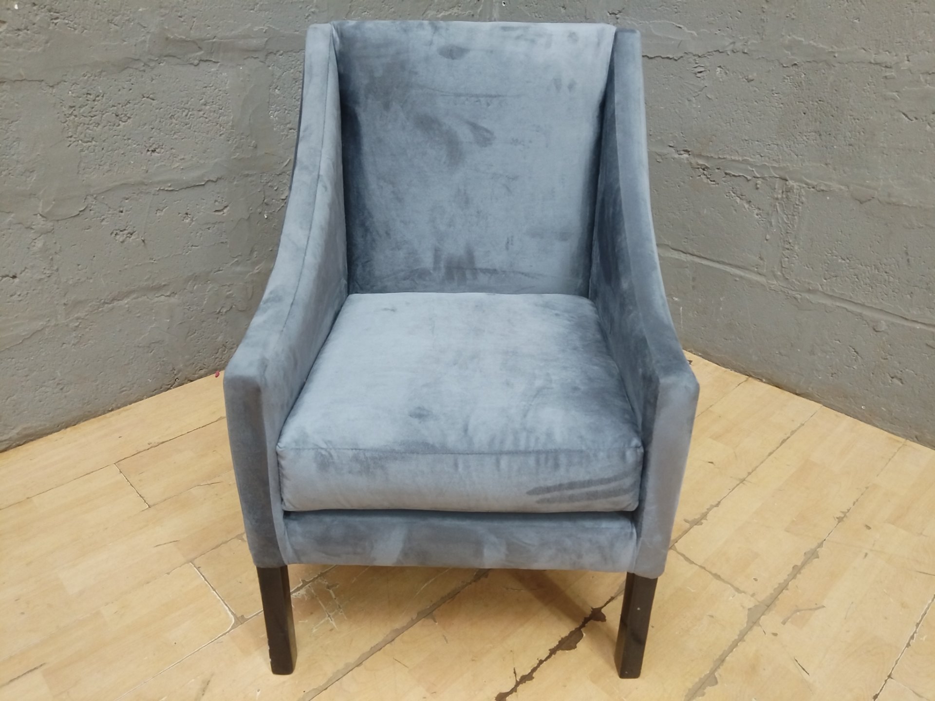 Grey velvet-look accent armchair — modern shape, tapered wooden legs, visible nap shading & light staining