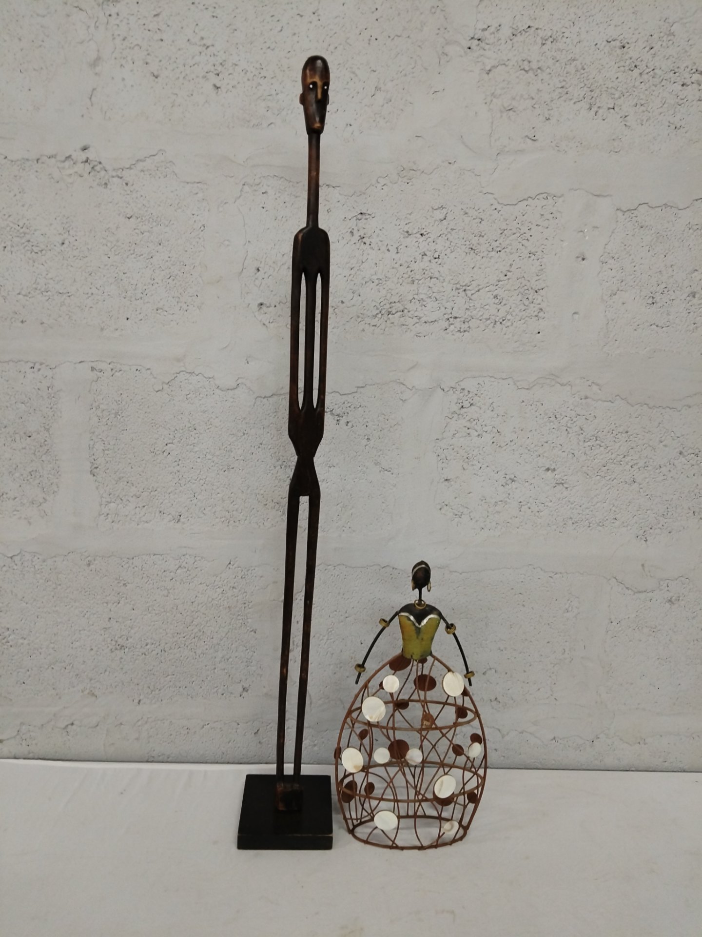 Pair of decorative sculptures – tall 94 cm wooden figure on fixed square base + 35 cm wire & shell skirt figure
