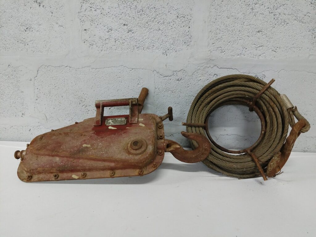 TIRFOR manual hand winch with coiled steel cable & hooks — working, heavy surface rust