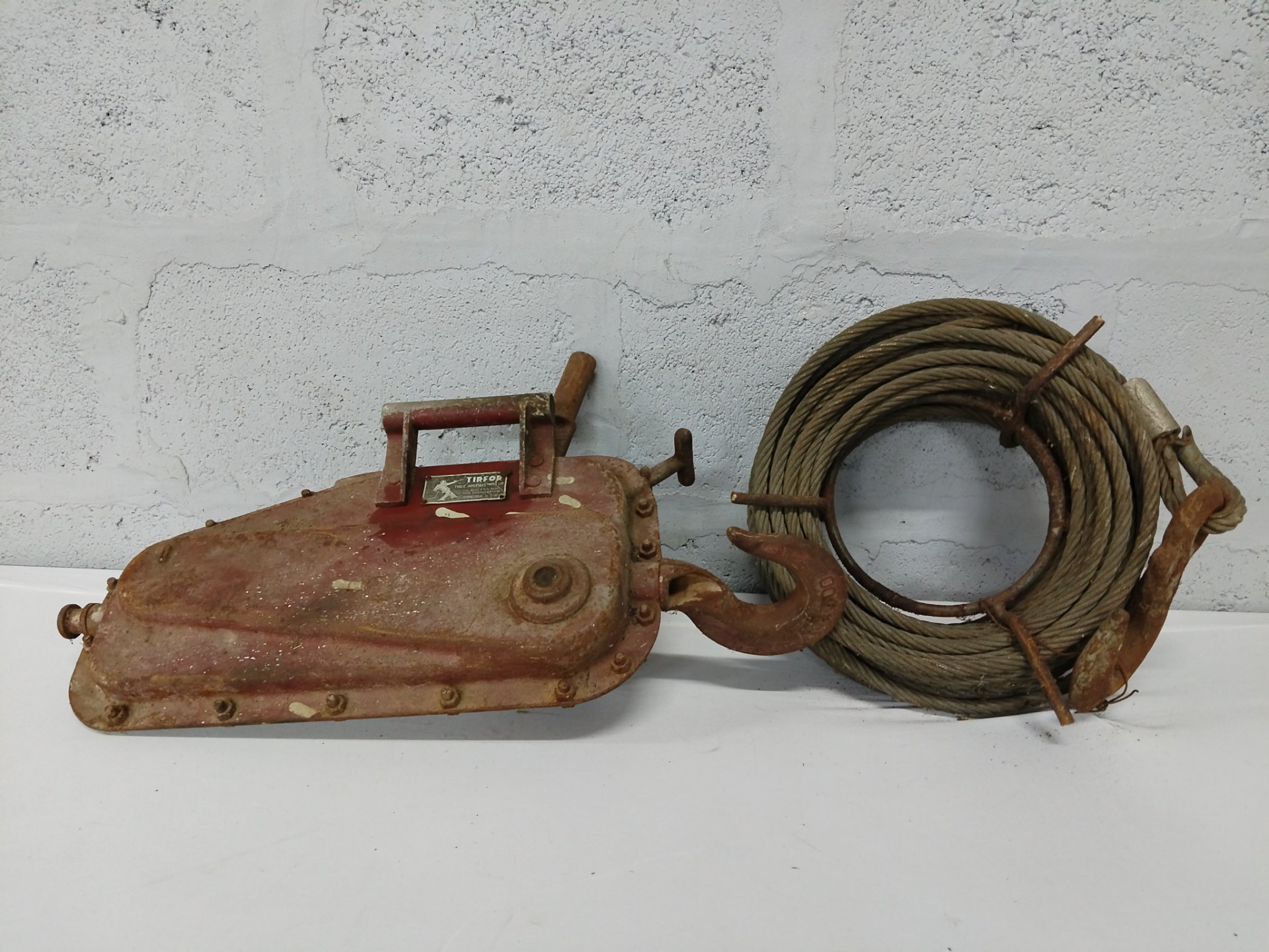 TIRFOR manual hand winch with coiled steel cable & hooks — working, heavy surface rust