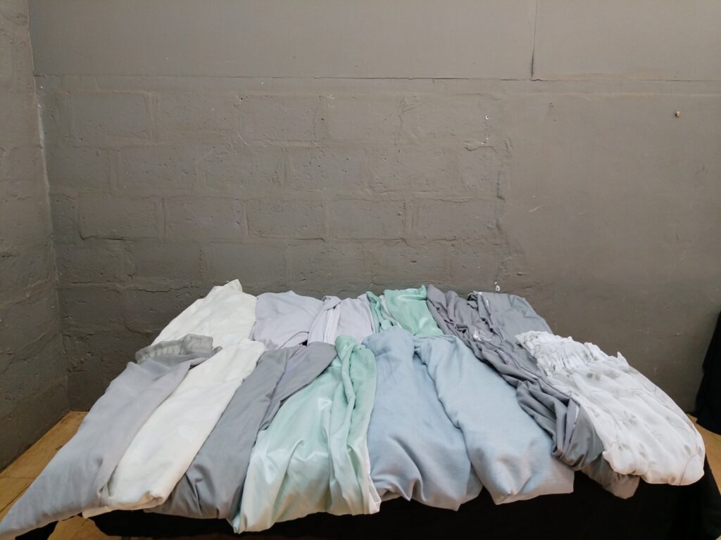 Lot of 15 mixed curtain panels – pale greys, greens & ivories, assorted sizes
