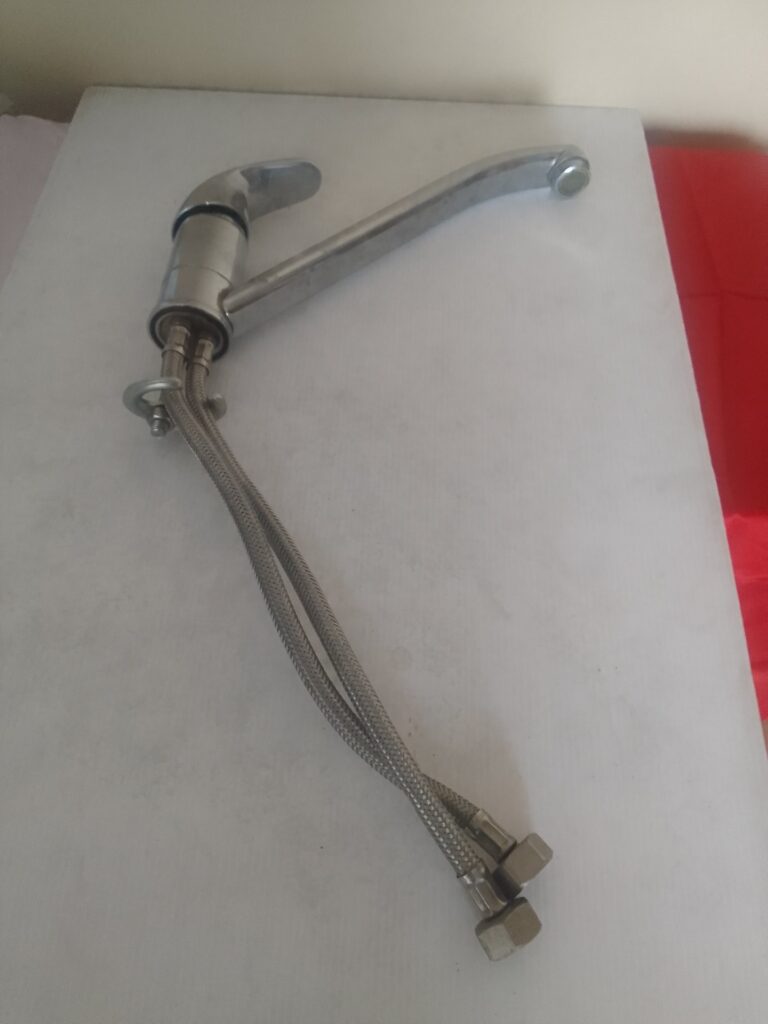 Used single‑lever kitchen/basin mixer tap with swivel spout and braided inlet hoses (untested)