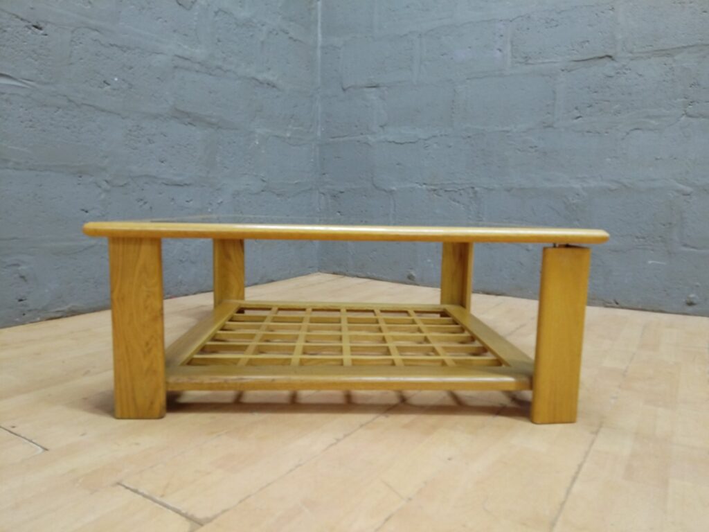 Square wooden coffee table with inset glass top and lower lattice shelf