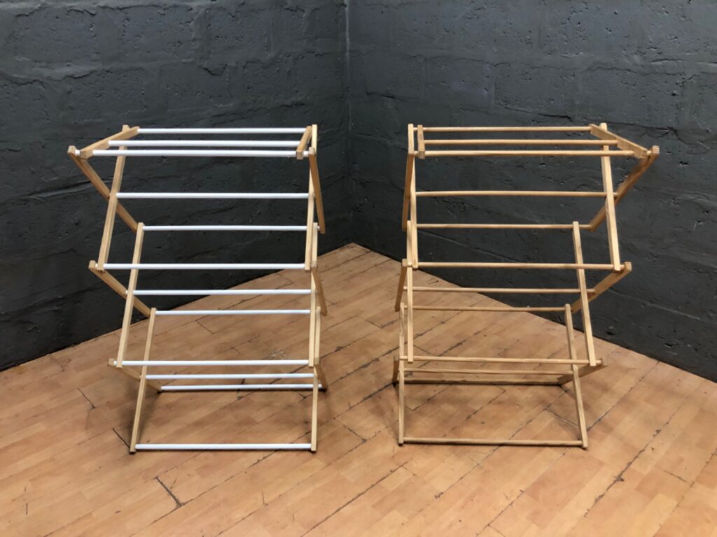 Pair of HOUSE OF YORK wooden folding clothes airers — X‑frame drying racks, one with white-coated rails