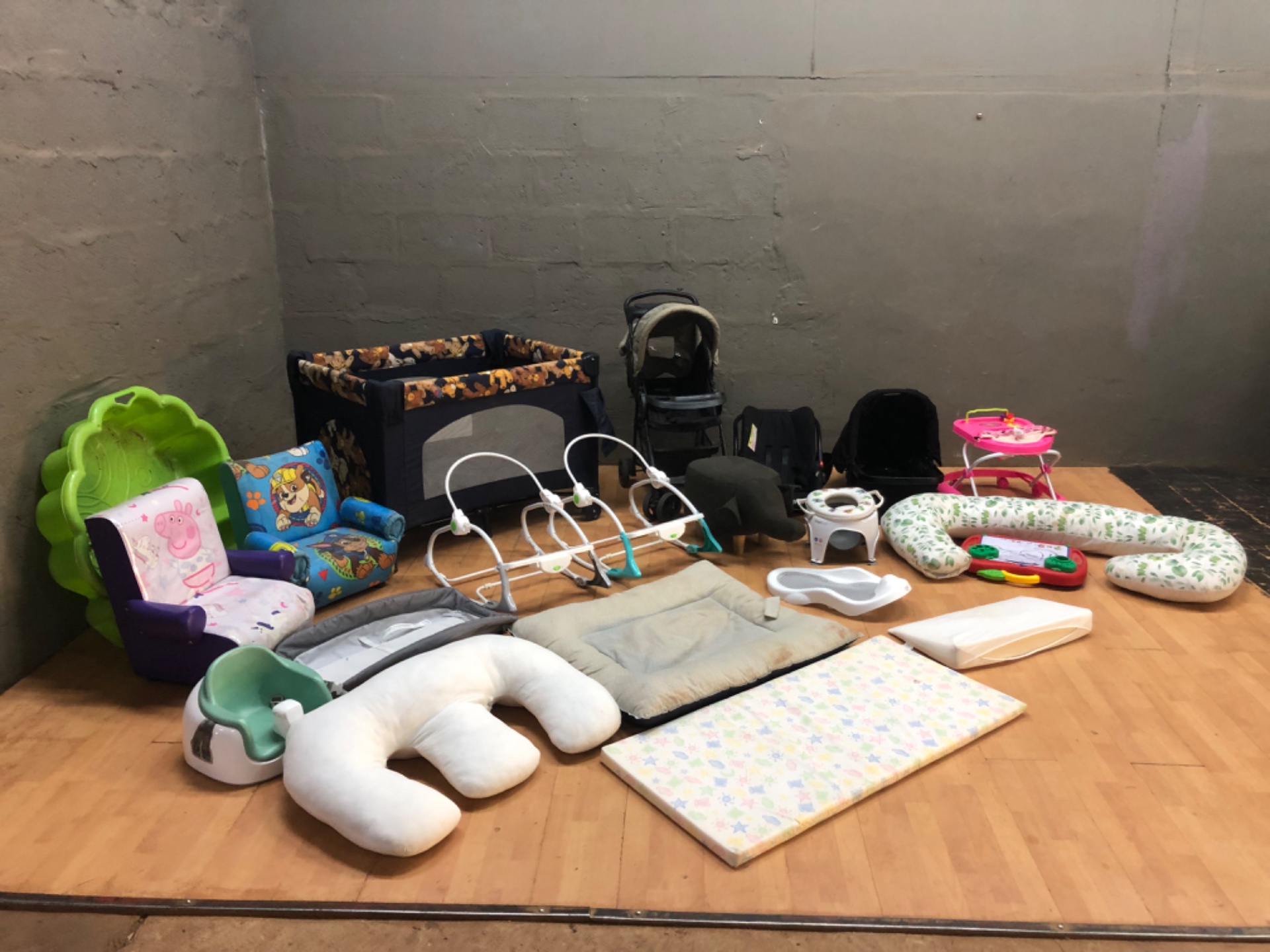 Mixed lot of baby gear — stroller, pack’n’play (hole in mesh), car seats (mimi visible), cushions, walkers & toys