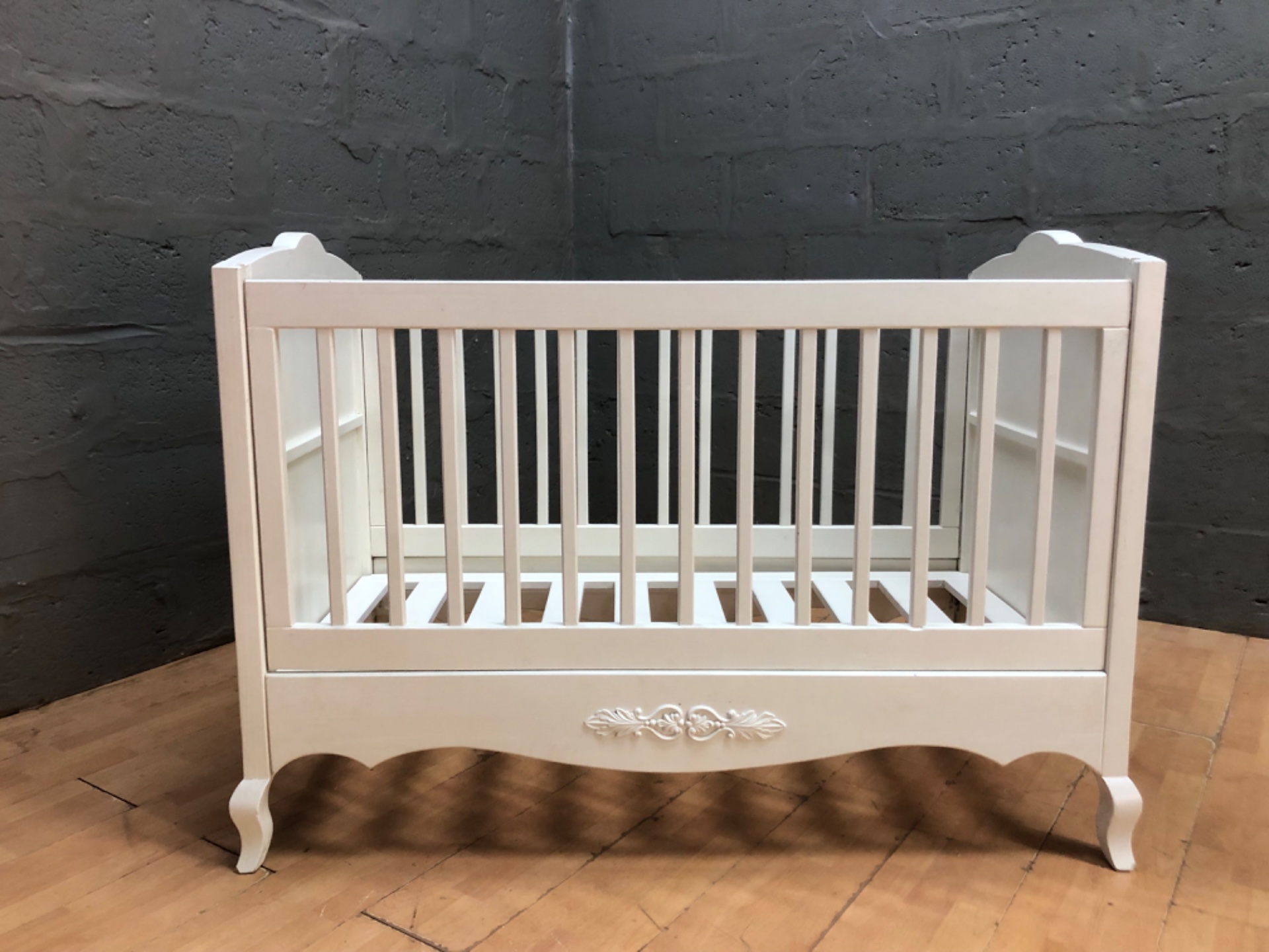 White decorative wooden baby cot / crib — carved appliqué, slatted base, assembled (no mattress)