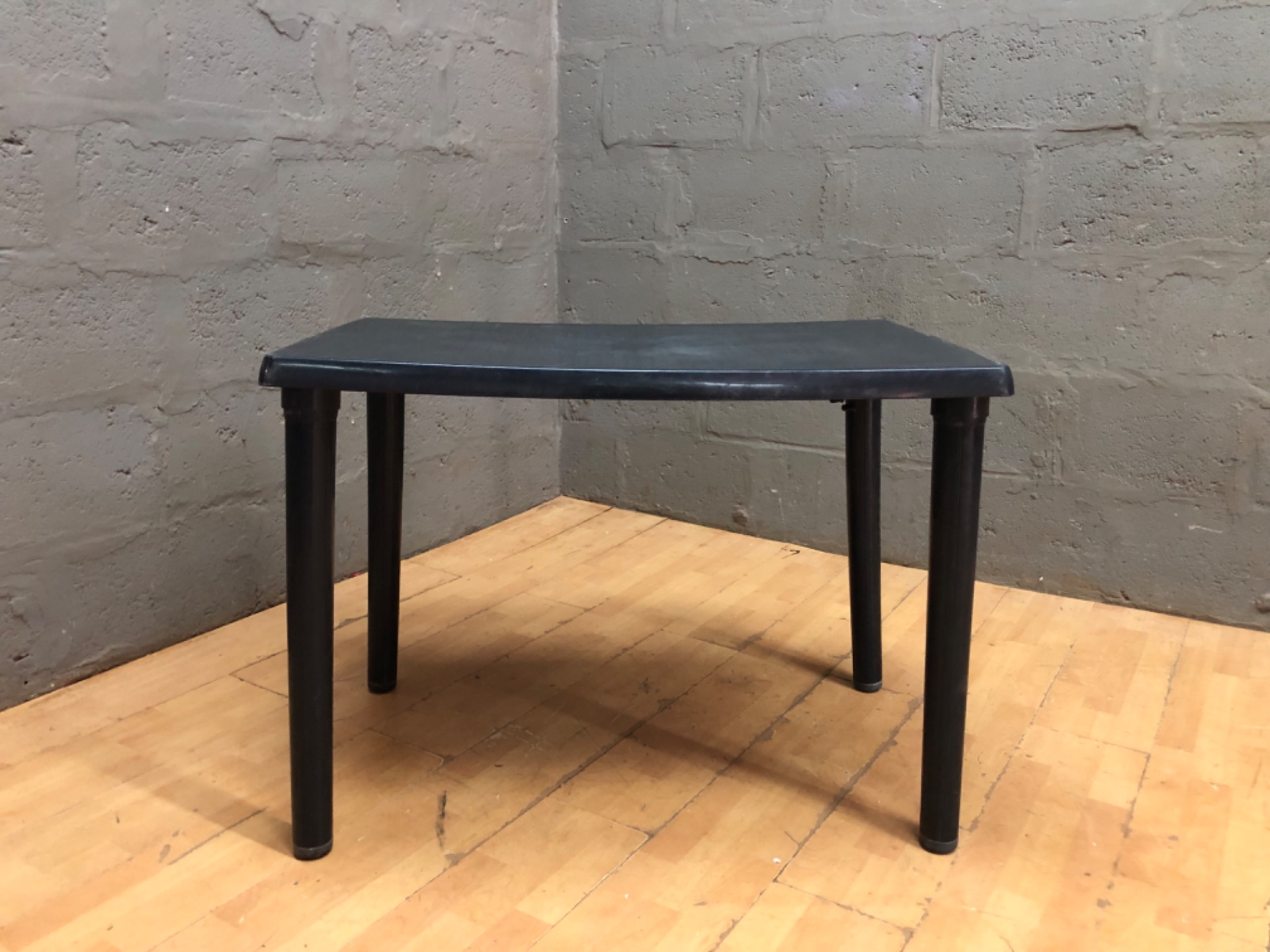 Black low plastic side/coffee table — textured top, 63 x 99 x 71 cm
