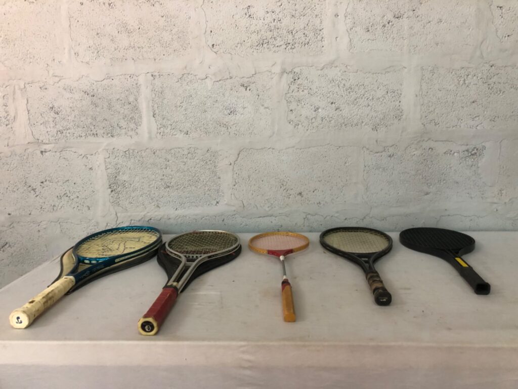 Lot of 5 used mixed tennis/badminton rackets (Slazenger + Orbit visible) — assorted grips, cover included