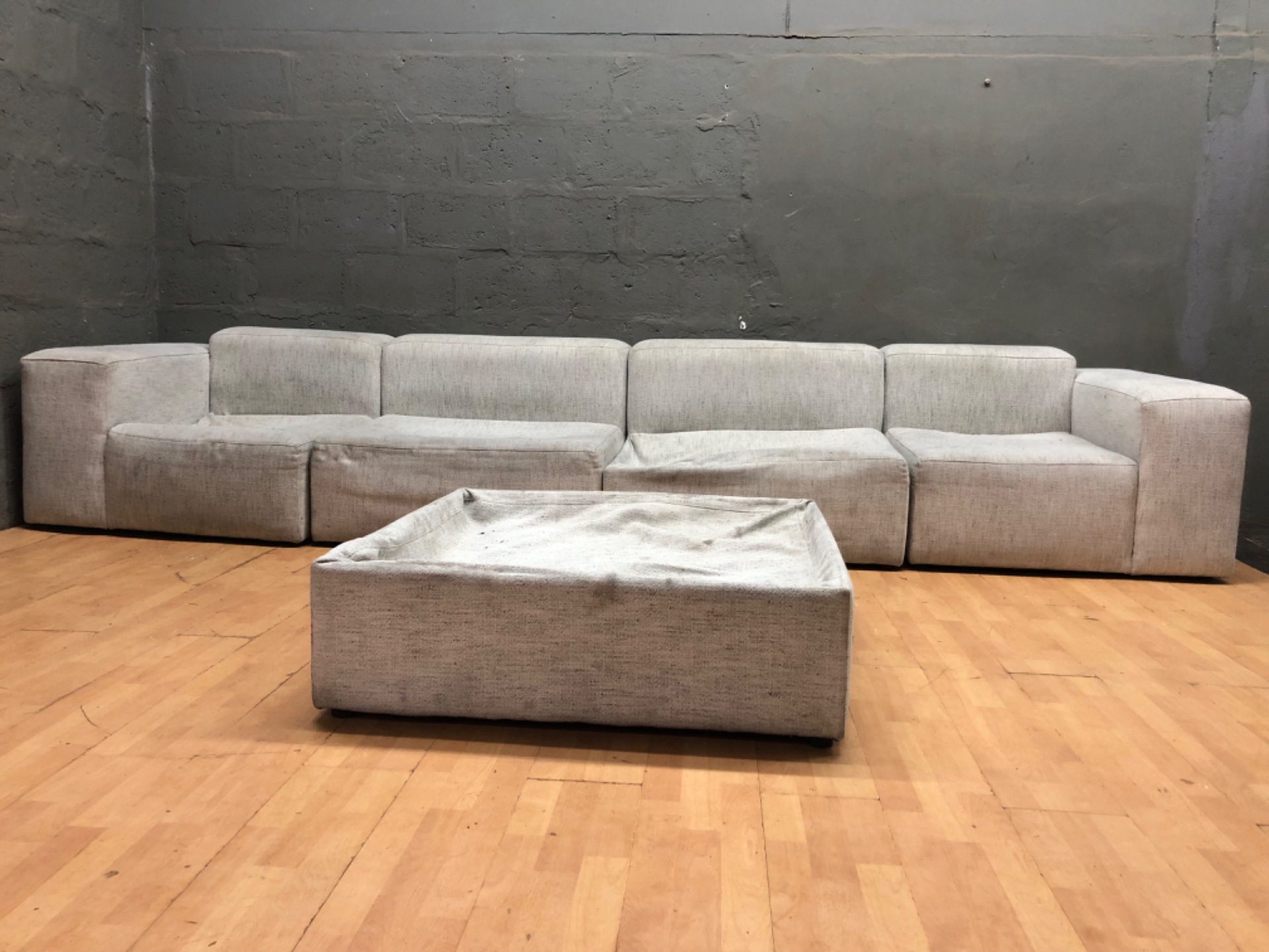 Large light‑grey modular sofa (4 modules + ottoman) – heavy soiling & structural damage