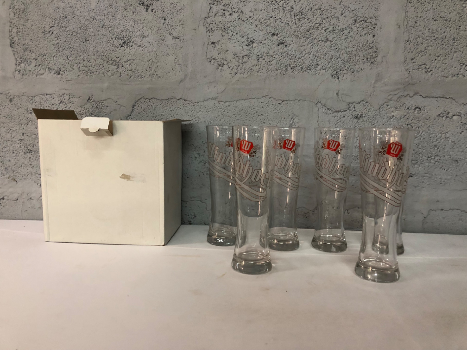 Set of 6 tall pilsner beer glasses with printed red logo — boxed, used with light wear
