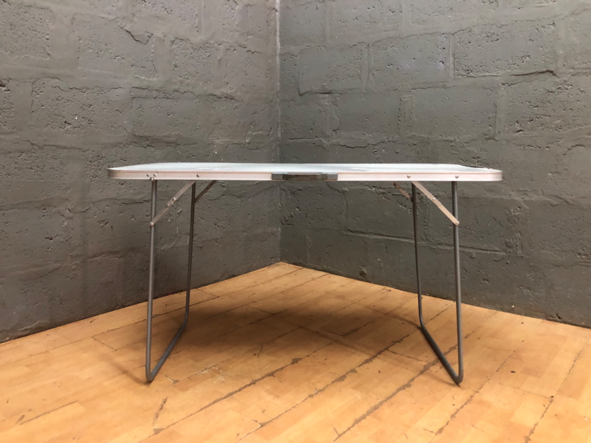 Folding portable camping table — laminate top, metal legs, 122 x 61 x 71 cm (used, cosmetic damage)