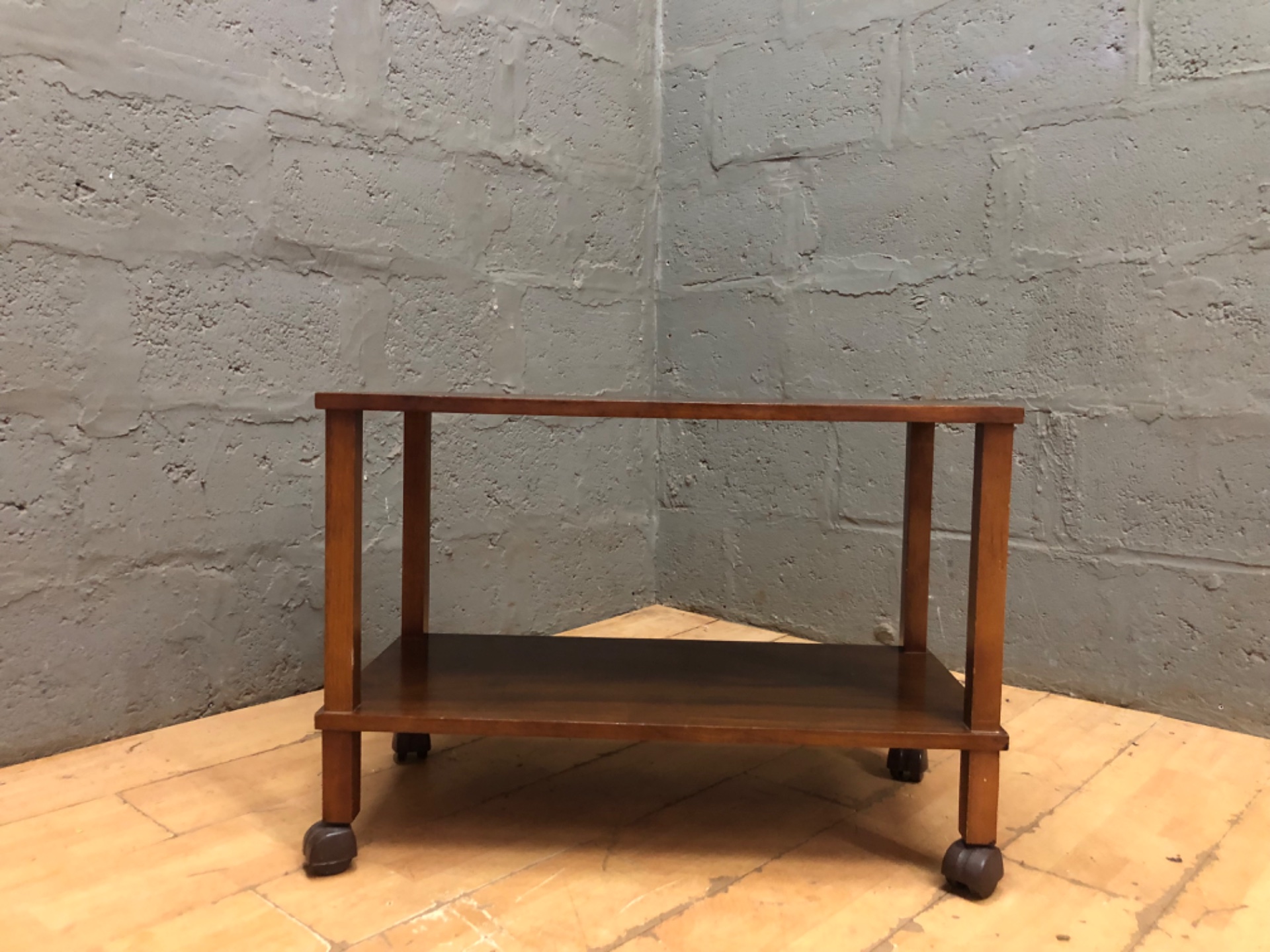 Wooden two-tier trolley / side table on castors — heavy top crazing, worn castors
