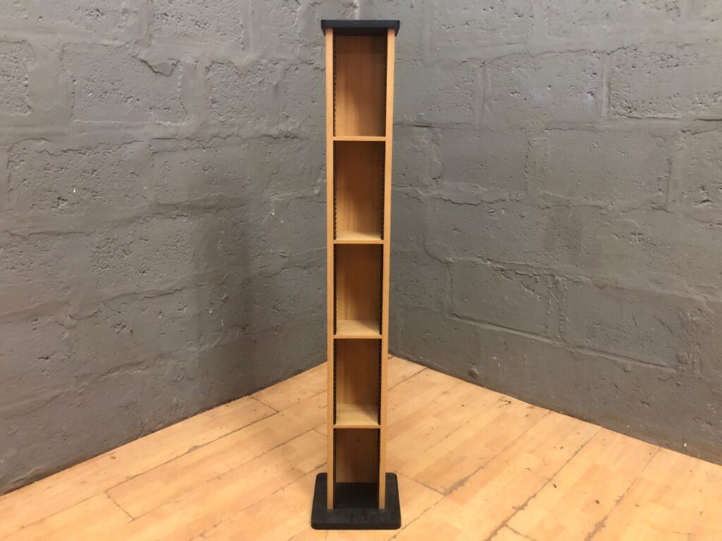 Tall slim wooden CD/DVD media tower with intact plastic disc rails, black base (133 x 24 x 25 cm)