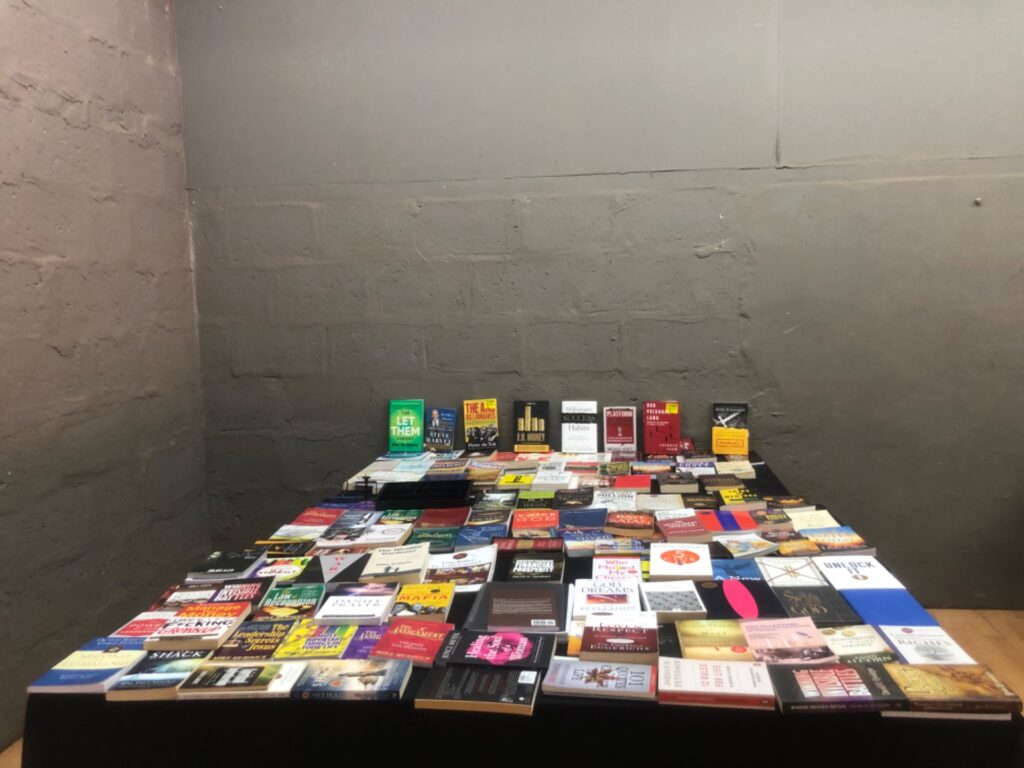 Bulk mixed lot of paperback and some hardcover books — business, self-help & Christian titles (displayed condition)