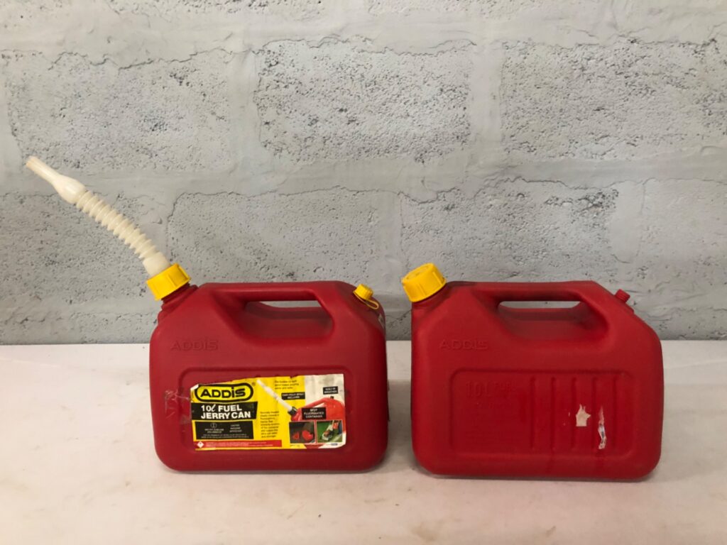Pair of ADDIS 10L red fuel jerry cans — one with flexible no‑spill spout, used condition
