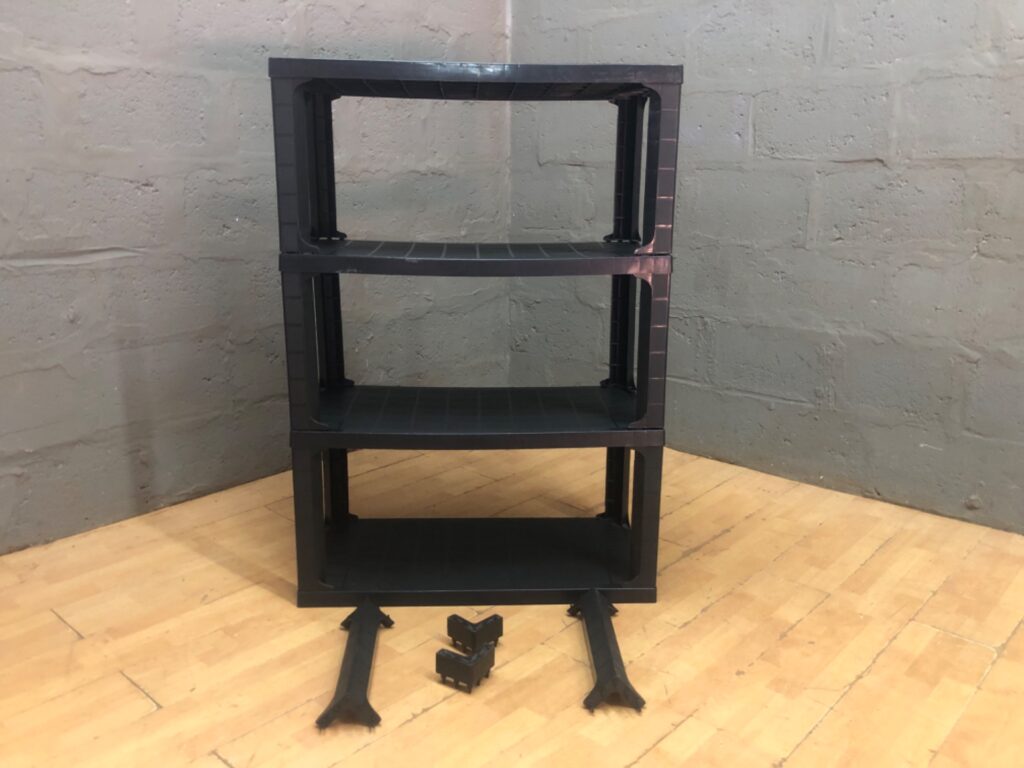 Black Stackable Plastic Shelving Unit — 4‑Tier (45 x 90 x 129 cm) — Detached Legs / Some Parts Missing
