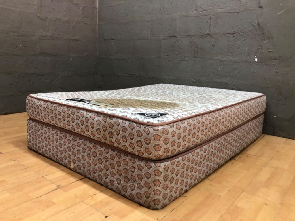 York Orthopaedic mattress with matching base — 136 × 190 × 44 cm (heavy staining, central sag)