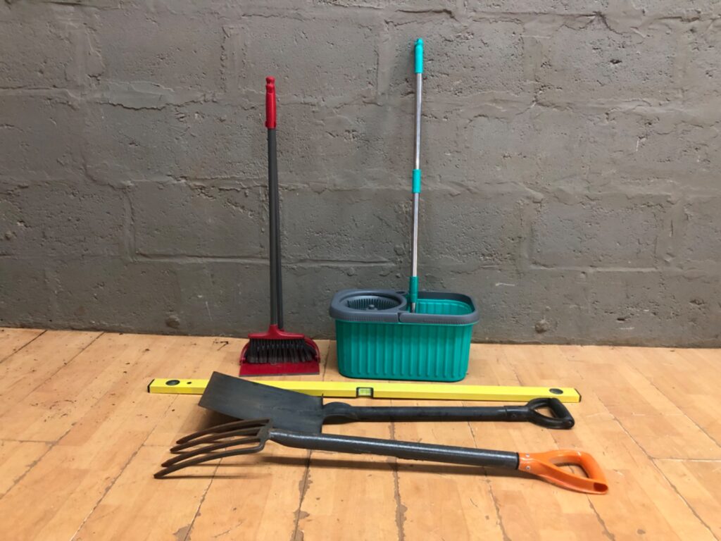 Mixed lot — Spin mop + bucket (wringer works), long-handled dustpan & broom, spirit level, shovel & 4‑tine garden fork — used, minor rust