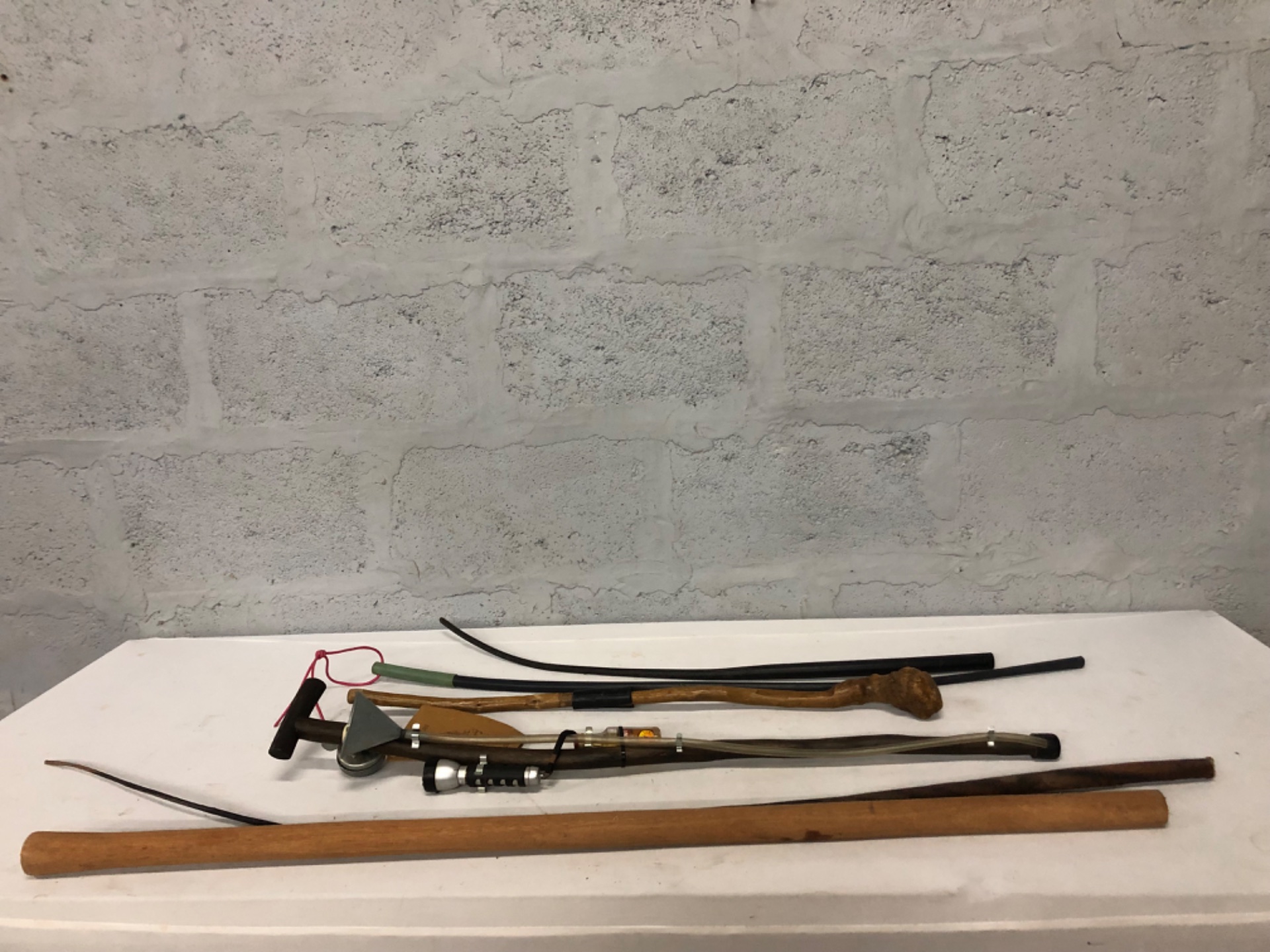 Mixed lot of 6 walking sticks / cane parts & accessories — carved ‘Chief’s Stick’ tag, tubing, funnel, torch (not working)