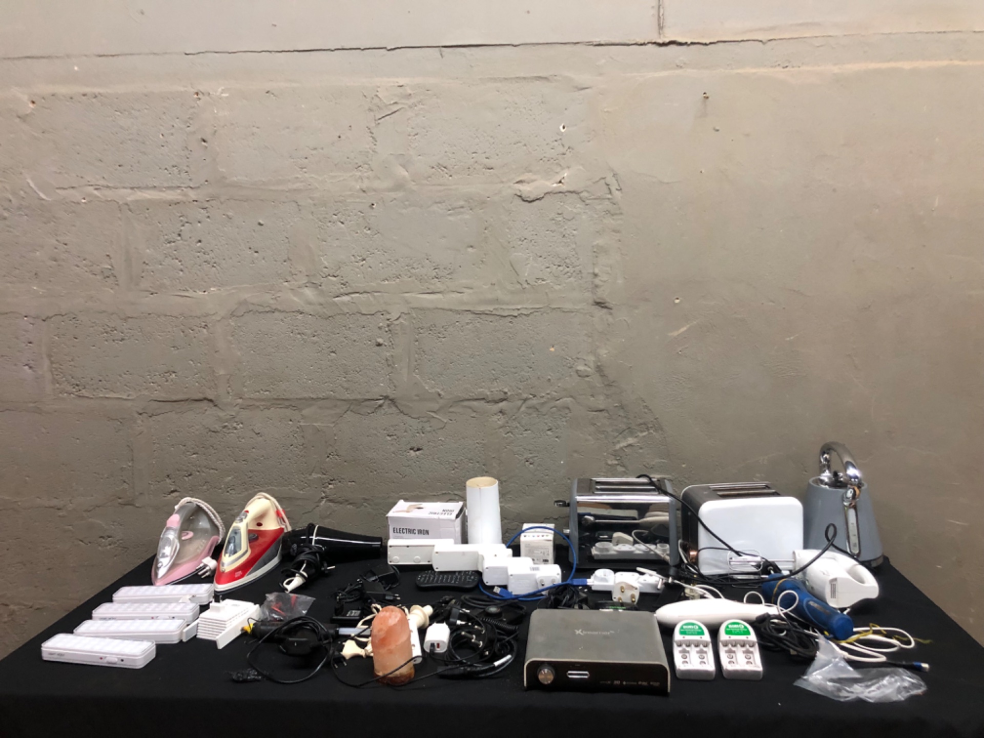 Mixed small electricals & appliances lot — irons, toasters, kettle, hair dryer, chargers, LED lights, adapters & cables (28 items est.)