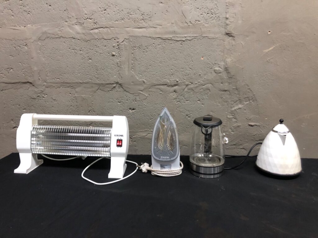 Mixed small countertop appliances — Goldair quartz heater, Bennett Read steam iron, 2 kettles (4 items) — Not working / for repair