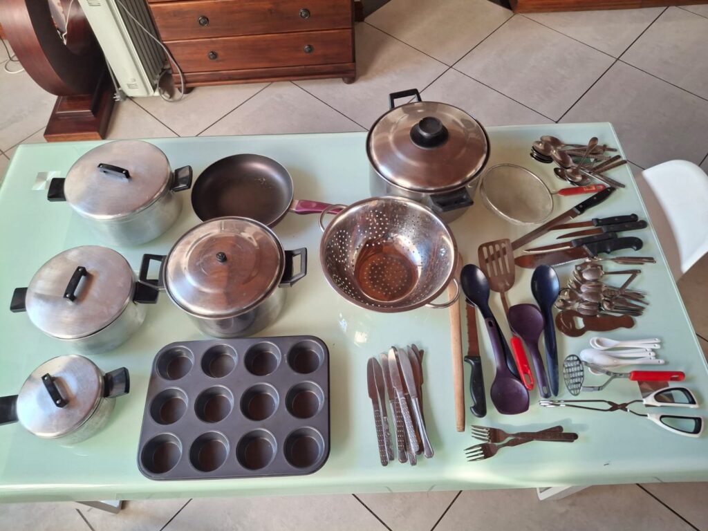 Lot 01 — Mixed Kitchenware: pots & lids, non-stick pan, colander, 12-cup muffin tin + cutlery & utensils